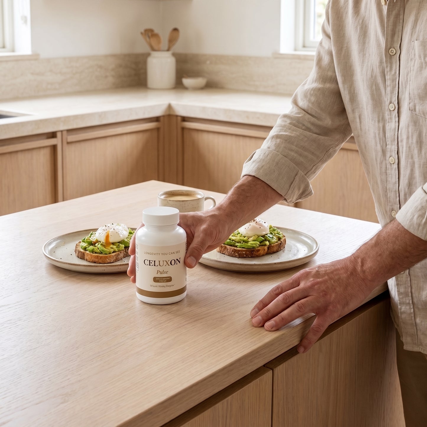 A man in a beige linen shirt stands at a light wood kitchen island holding a white bottle labeled CELUXON Pure. Two plates of avocado toast sit on the counter in the background of a bright, modern kitchen.