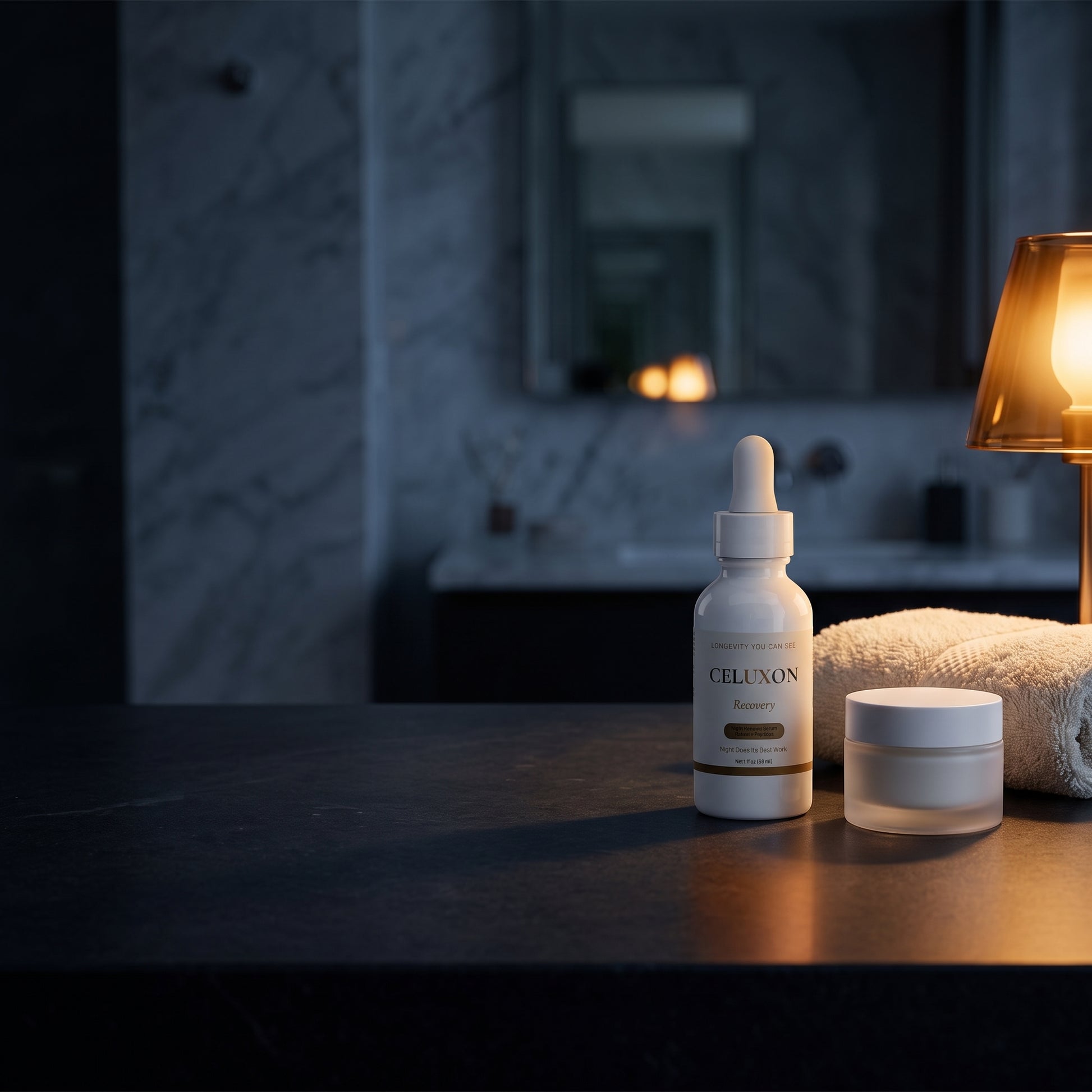 A skincare set featuring a white dropper bottle labeled CELLULON and a matching white jar, styled on a dark countertop with a lit lamp and a towel in a dimly lit bathroom setting.