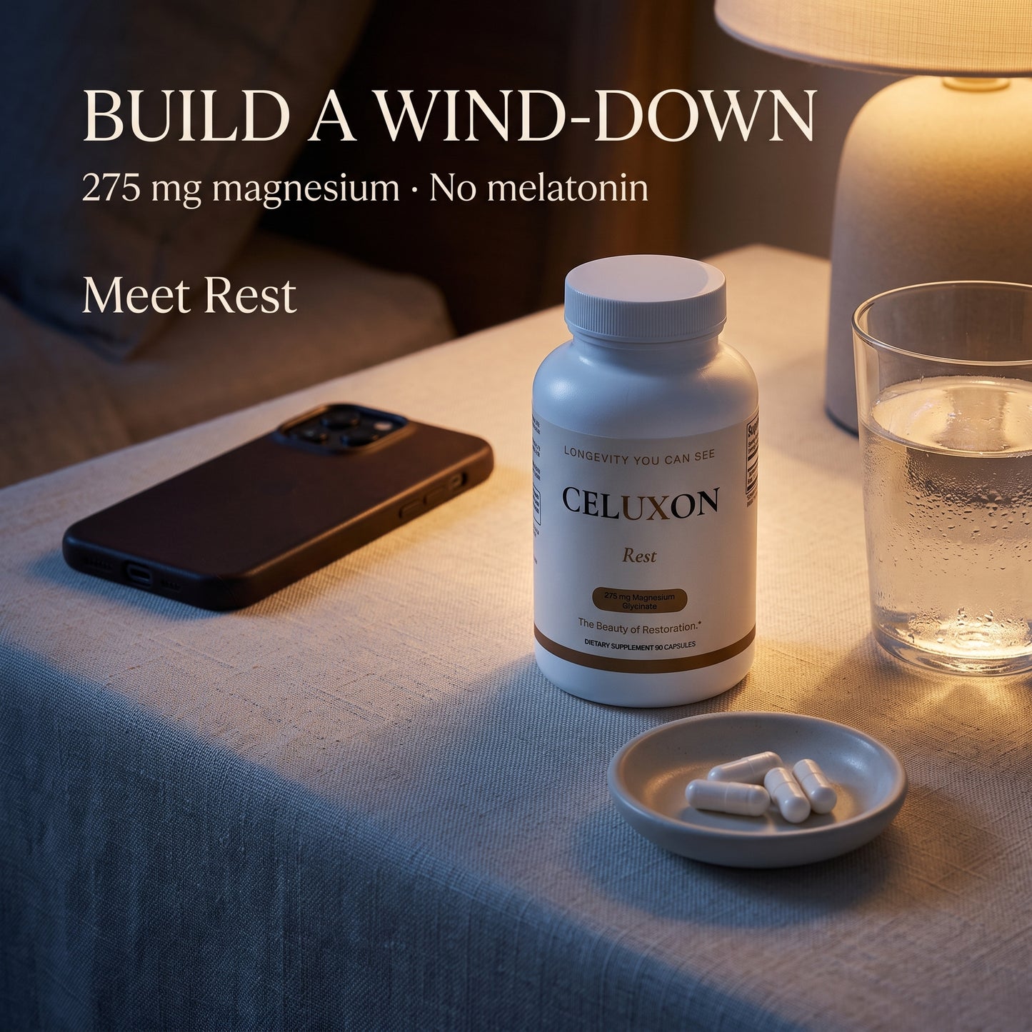 A bottle of CELUXON Rest magnesium supplement sits on a table next to a glass of water, a smartphone, and a small dish of capsules under warm indoor lighting. Text on the image reads 'BUILD A WIND-DOWN 275 mg magnesium • No melatonin Meet Rest'.